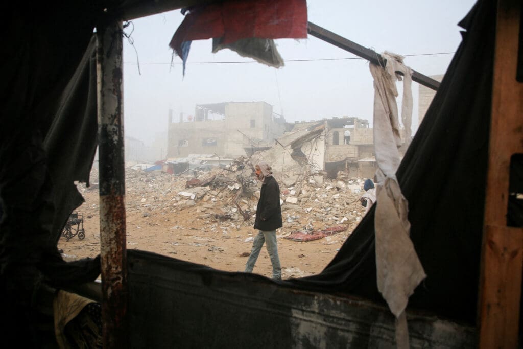 Palestinians inspect the damage to a tent for displaced people, after an Israeli airstrike, in Khan Younis