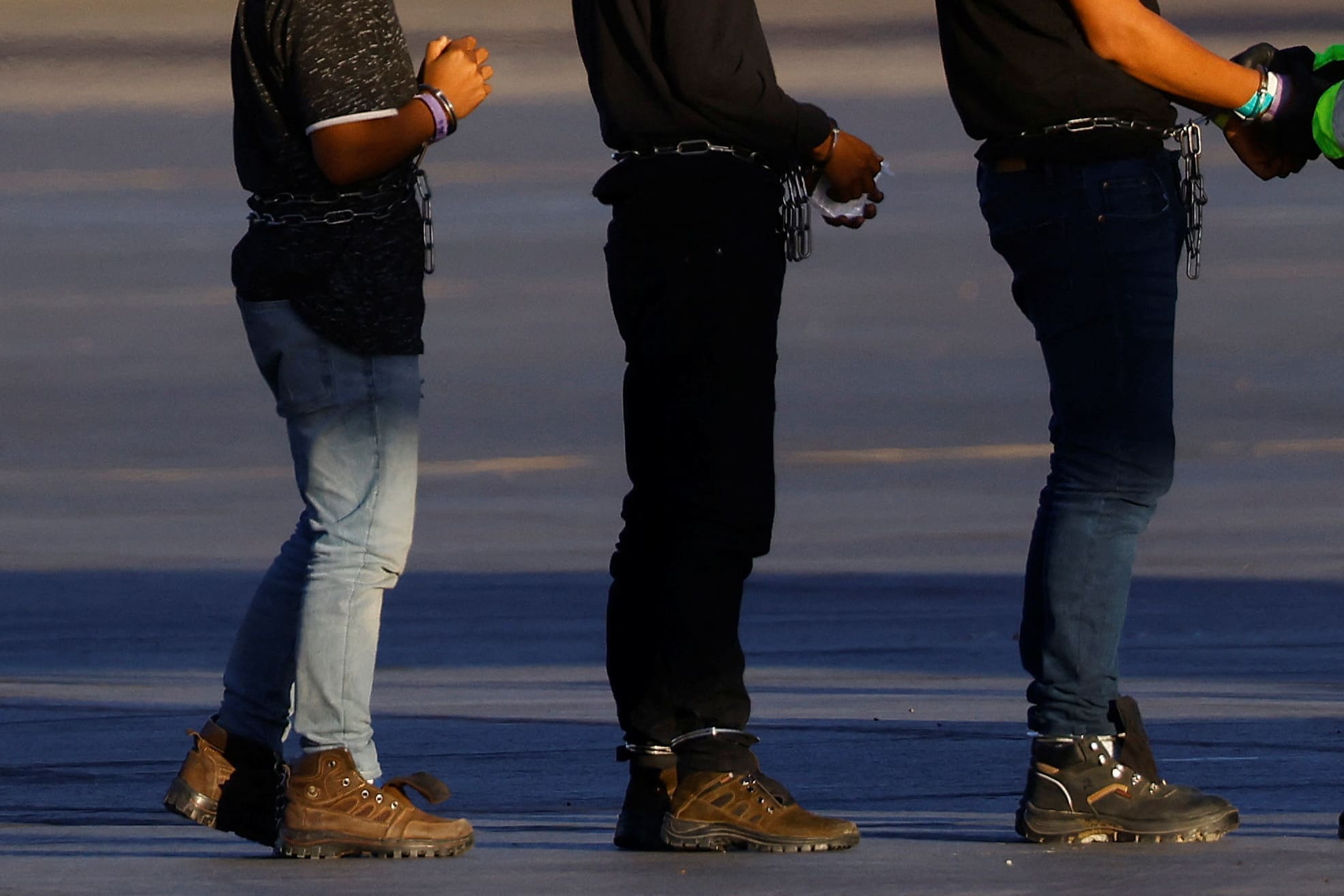 Migrants are transferred to a plane to be expelled under Title 42 from U.S., in El Paso