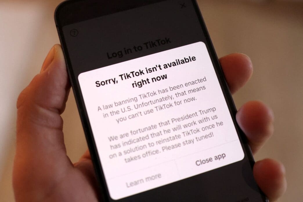 Illustration shows TikTok app with the message "Sorry, TikTok isn't available right now