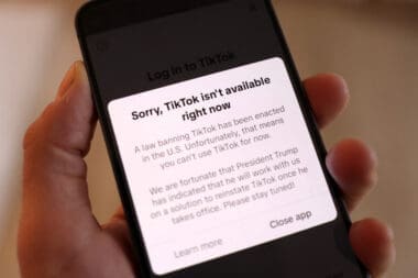 Illustration shows TikTok app with the message "Sorry, TikTok isn't available right now