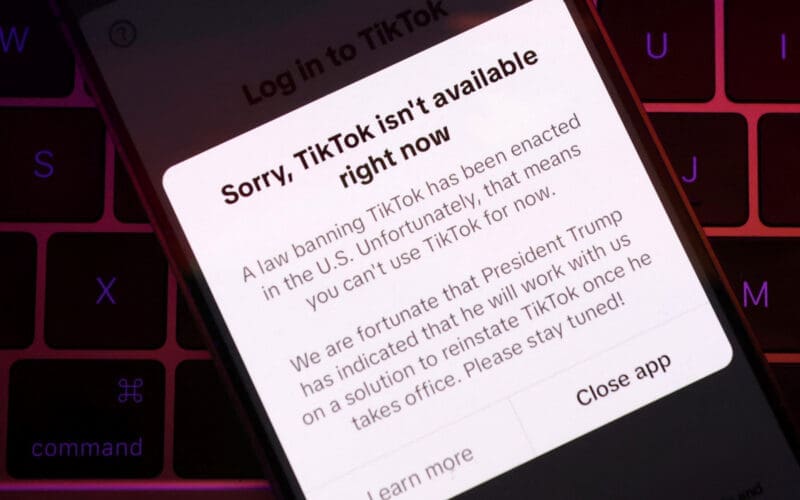 Illustration shows TikTok app with the message "Sorry, TikTok isn't available right now