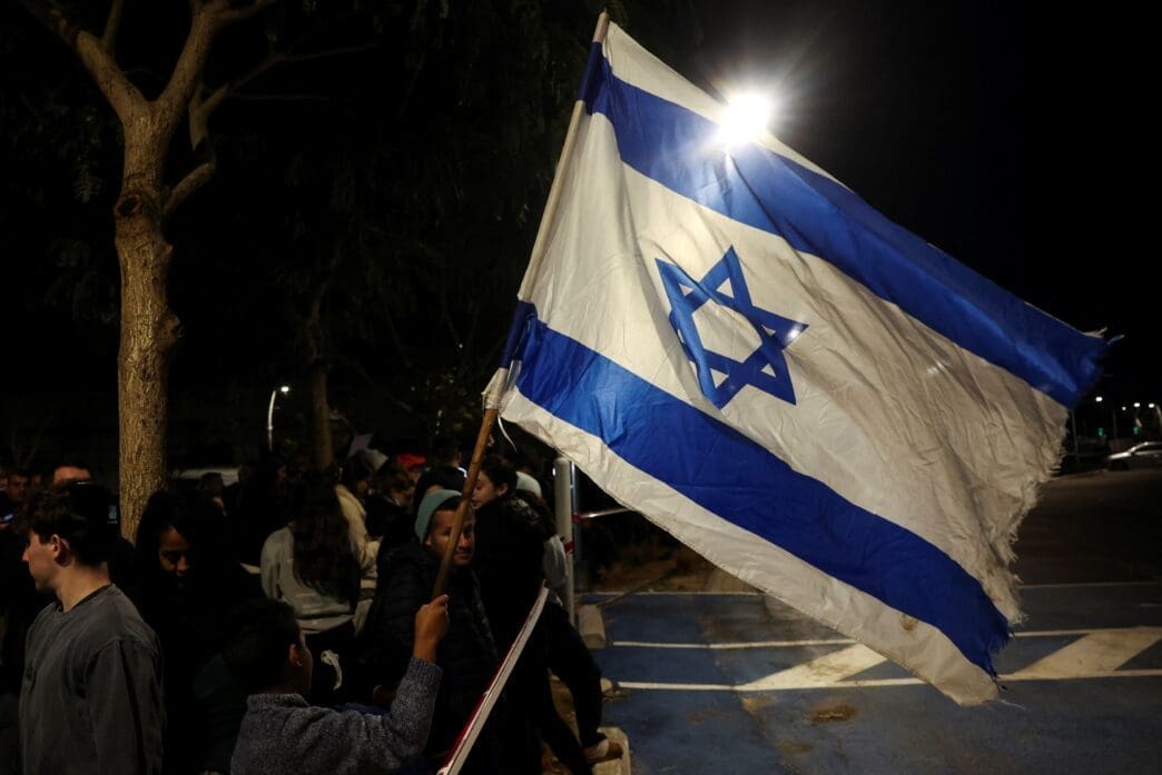 People gather, ahead of the expected release of three female hostages, in Ramat Gan