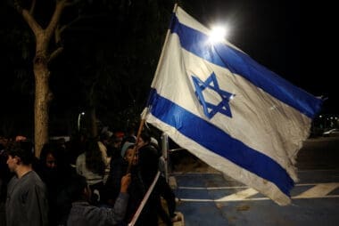 People gather, ahead of the expected release of three female hostages, in Ramat Gan