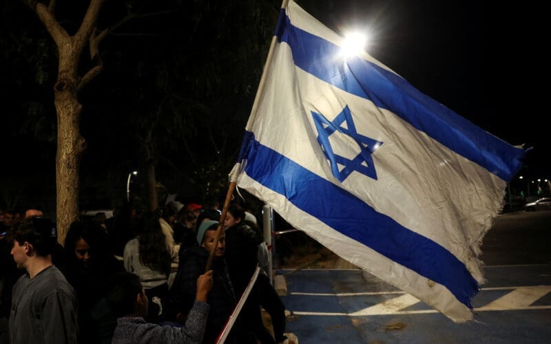 People gather, ahead of the expected release of three female hostages, in Ramat Gan