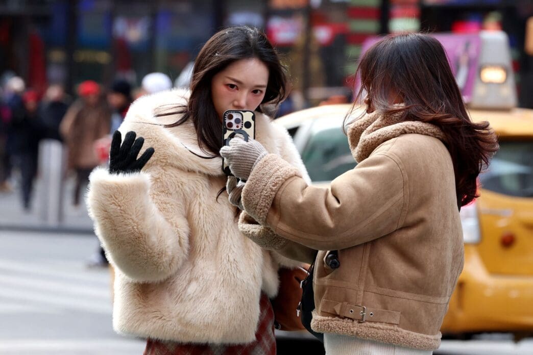 A Social Media influencer films a video in Times Square in New York