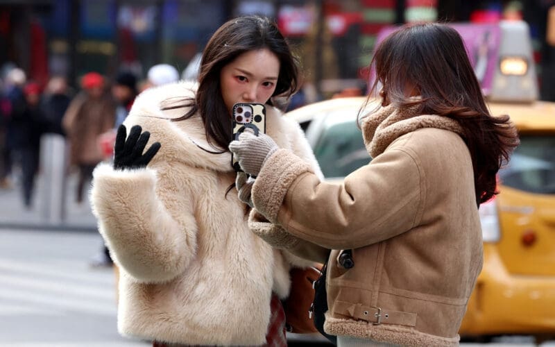 A Social Media influencer films a video in Times Square in New York