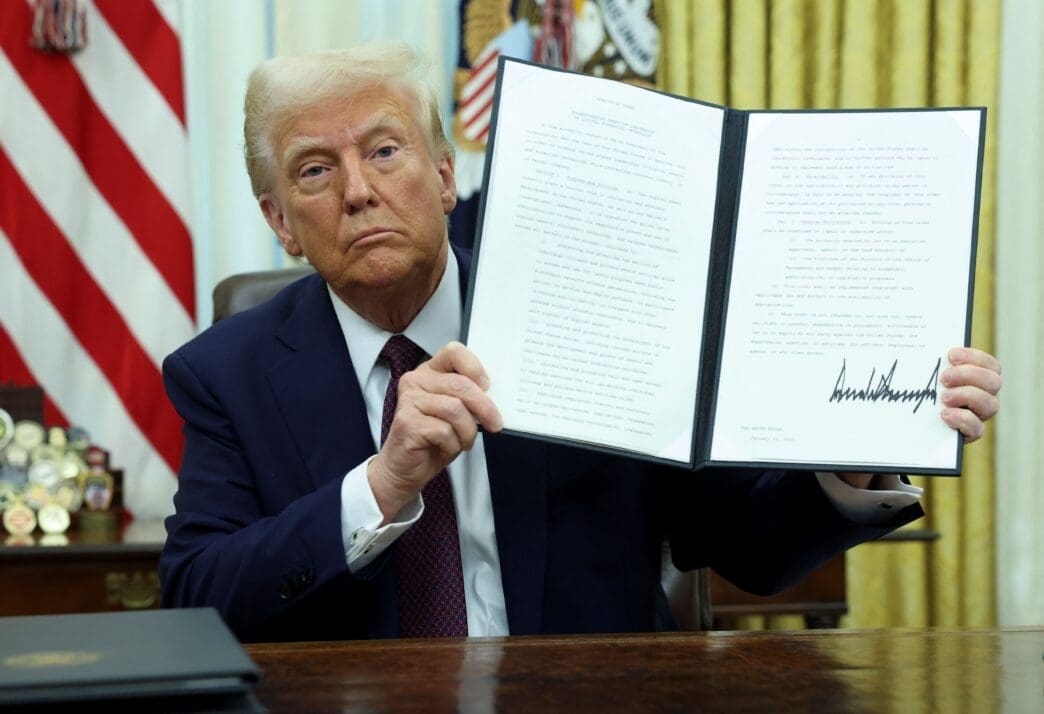 U.S. President Trump signs an executive order in the Oval Office, at the White House