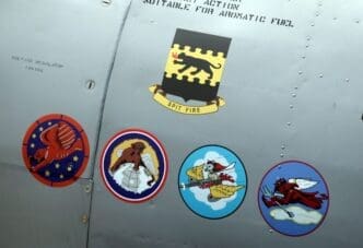 The insignias for five Tuskegee Airmen squads seen on side of AY-6 Texan fighter plane during ceremony to honor the airmen at Selfridge National Airbase in Harrison Township