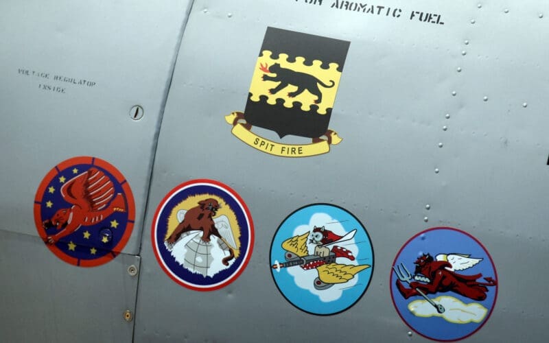 The insignias for five Tuskegee Airmen squads seen on side of AY-6 Texan fighter plane during ceremony to honor the airmen at Selfridge National Airbase in Harrison Township