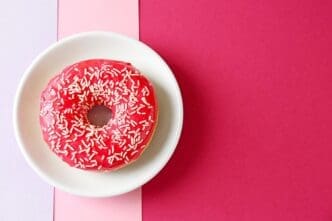 A plate featuring a delectable red donut