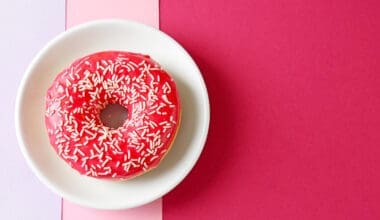 A plate featuring a delectable red donut