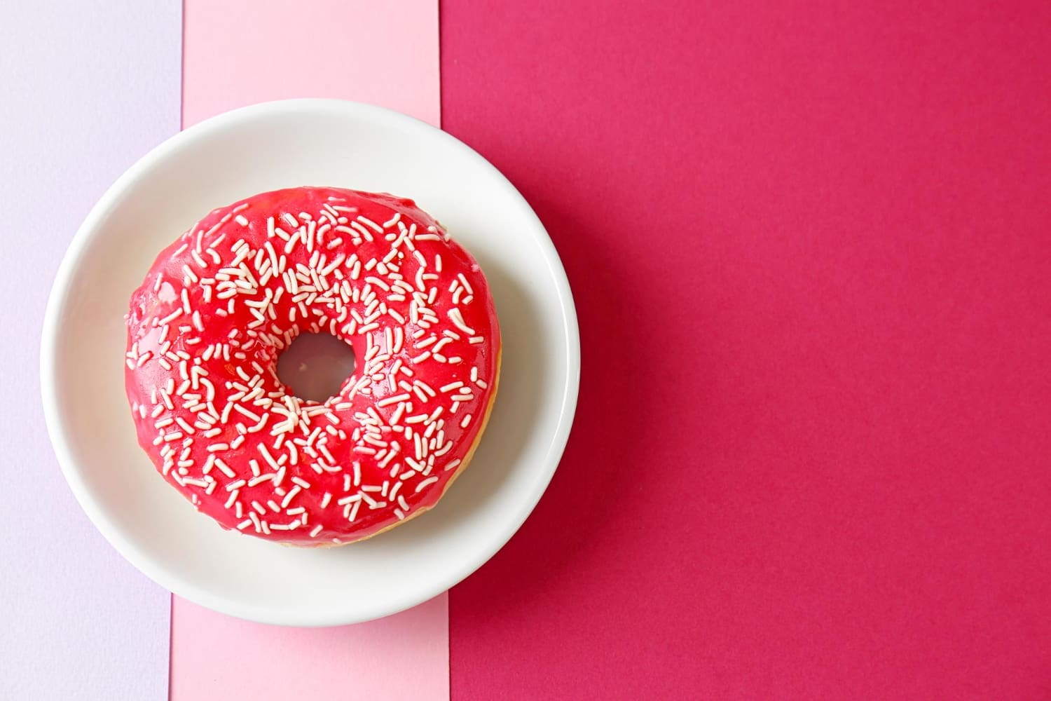 A plate featuring a delectable red donut