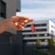 A person holding keys outside to signify the sale of a house