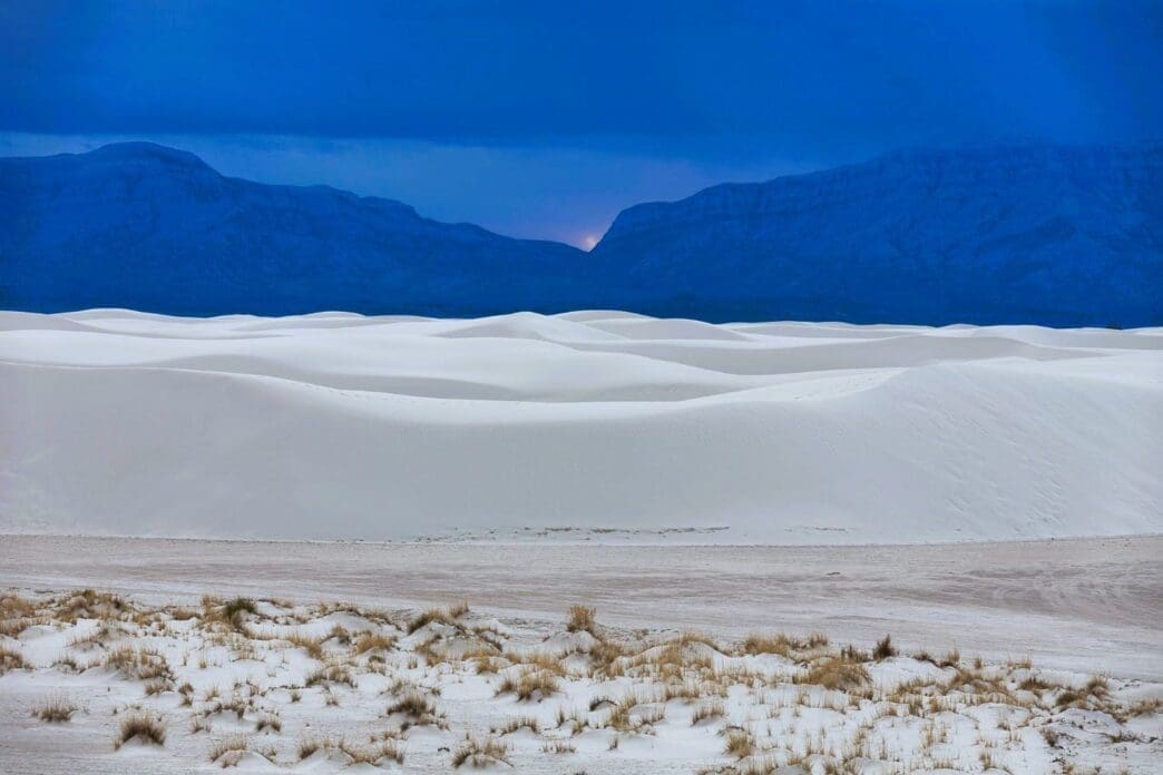 A picturesque view of White Sands National Monument set against the sky at sunset