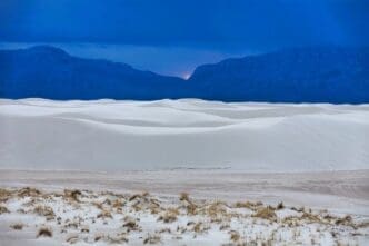 A picturesque view of White Sands National Monument set against the sky at sunset