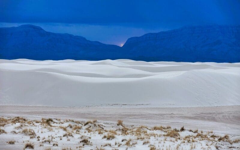 A picturesque view of White Sands National Monument set against the sky at sunset