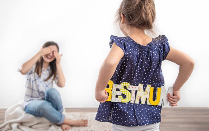 A sweet little girl celebrates her mother