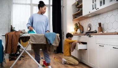 A woman is diligently cleaning a messy house while her young boy helps out, fostering teamwork and instilling habits of responsibility and cooperation in household chores