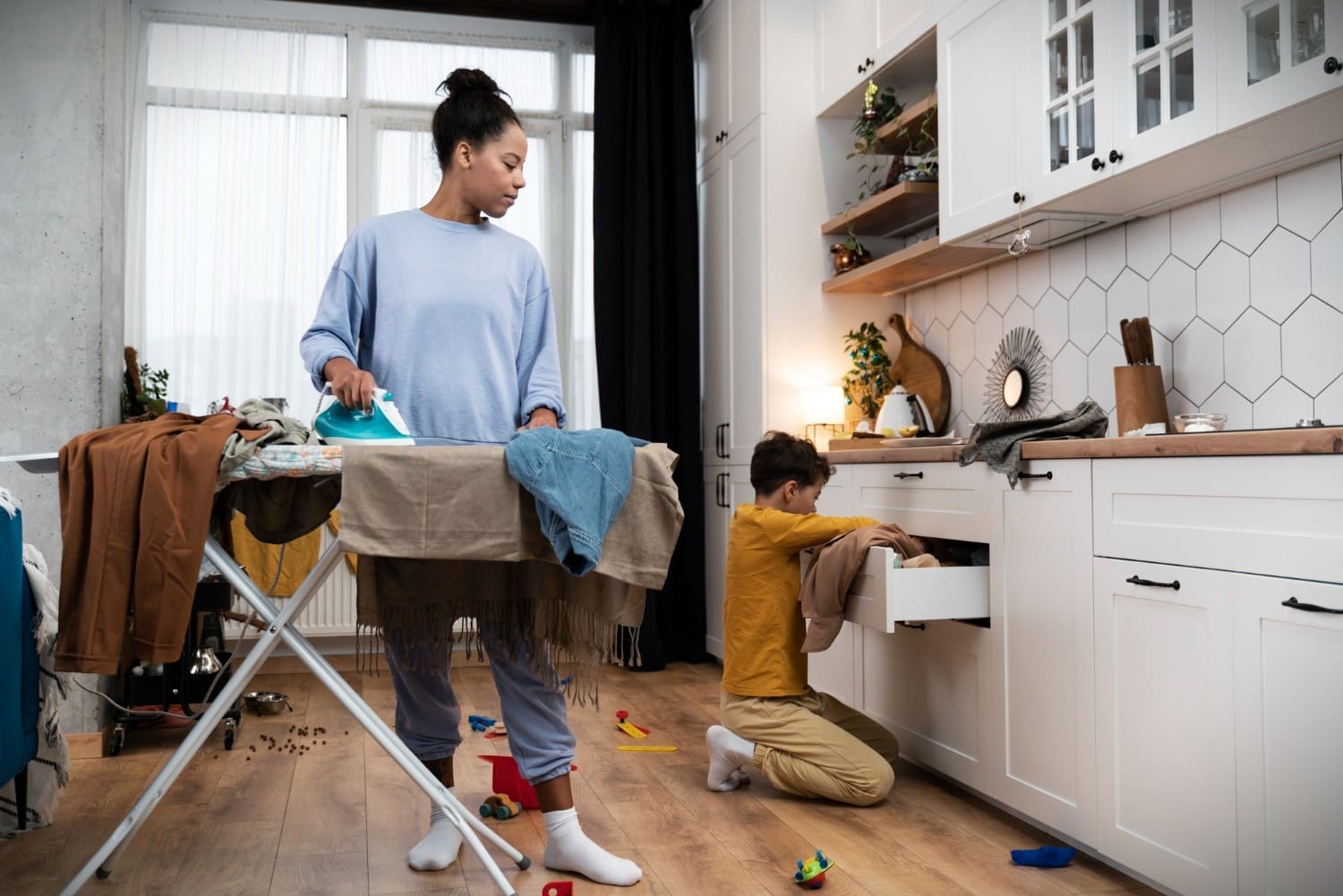 A woman is diligently cleaning a messy house while her young boy helps out, fostering teamwork and instilling habits of responsibility and cooperation in household chores