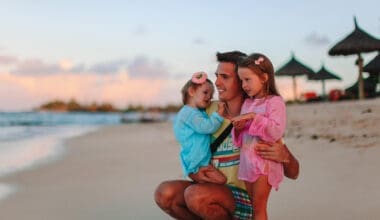 A young dad enjoying a vacation with his two young daughters