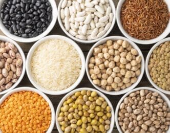 Assorted beans and grains on white bowls