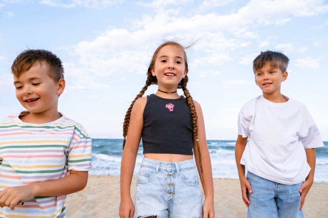 Children enjoying themselves at the beach from a front view