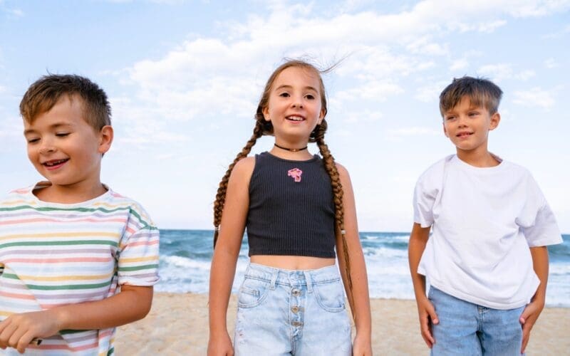 Children enjoying themselves at the beach from a front view