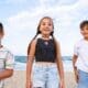 Children enjoying themselves at the beach from a front view