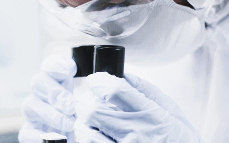 Close-up of a scientist examining asteroid samples