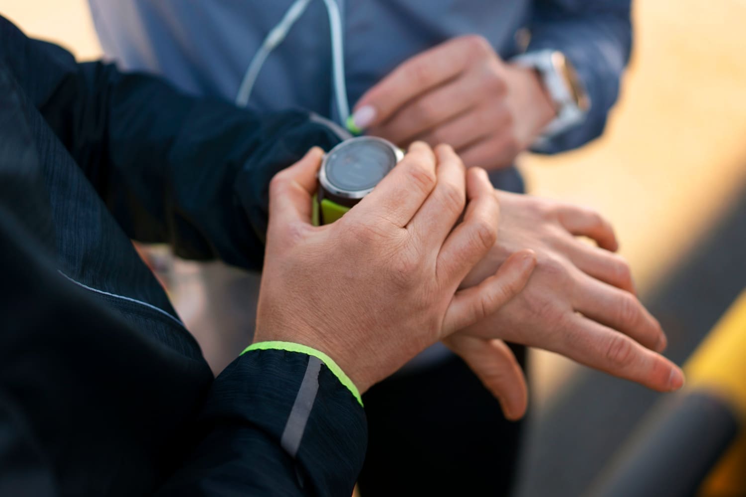 Close-up shot of two men preparing to work out together