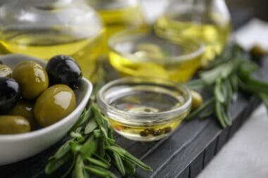 Composition with healthy olives and oil on kitchen table