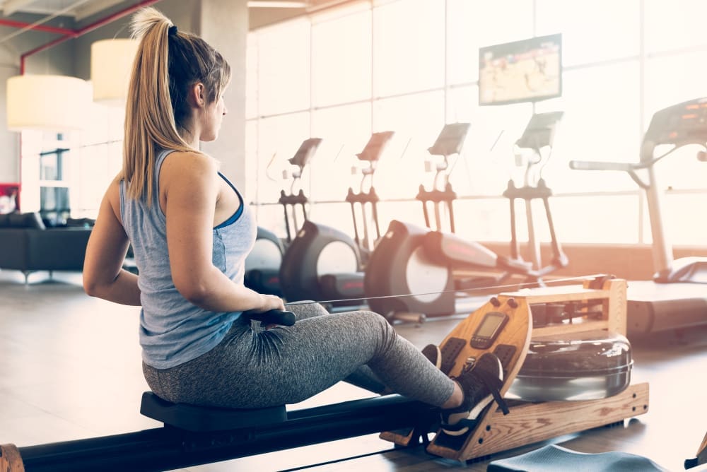 Fitness enthusiast working out on a rowing machine