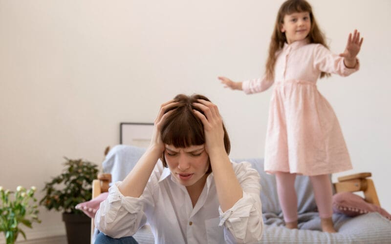 Medium shot of a woman experiencing a headache