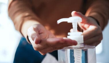 Norovirus protection A close-up of her cleaning her hands with hand sanitizer gel