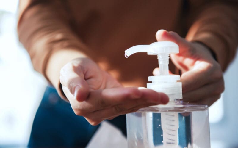 Norovirus protection A close-up of her cleaning her hands with hand sanitizer gel