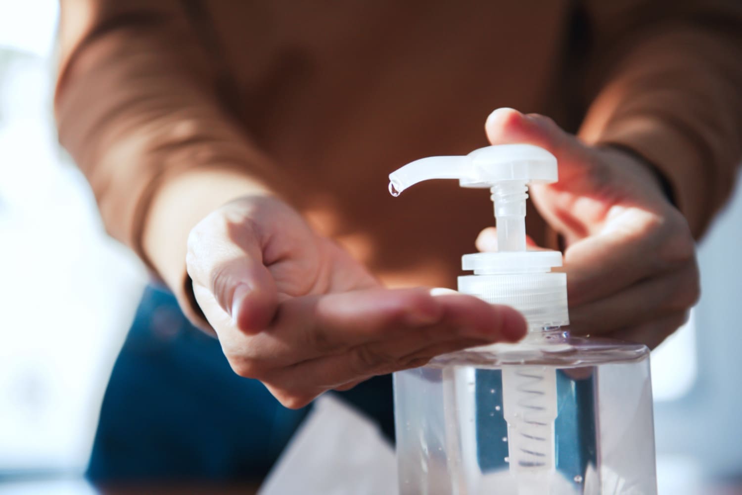 Norovirus protection A close-up of her cleaning her hands with hand sanitizer gel