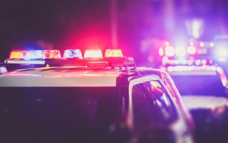 Police cruiser lights at a nighttime checkpoint