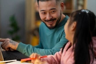 Profile view of a man assisting his daughter with her schoolwork