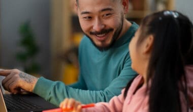 Profile view of a man assisting his daughter with her schoolwork