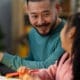 Profile view of a man assisting his daughter with her schoolwork