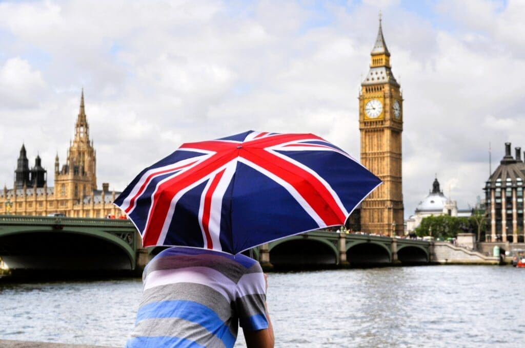 Young man gazing at the River Thames from behind