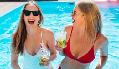 A medium shot captures two young women friends sharing a laugh