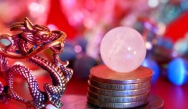 A Chinese dragon statuette with coins and a quartz crystal ball. Reiki, fortune telling, esotericism and horoscope