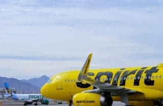 A bright yellow Spirit Airlines Airbus A320 passenger jet departs from Phoenix Sky Harbor International Airport (PHX)