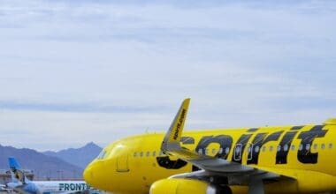 A bright yellow Spirit Airlines Airbus A320 passenger jet departs from Phoenix Sky Harbor International Airport (PHX)