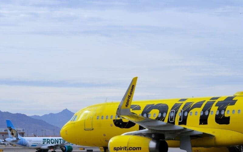 A bright yellow Spirit Airlines Airbus A320 passenger jet departs from Phoenix Sky Harbor International Airport (PHX)