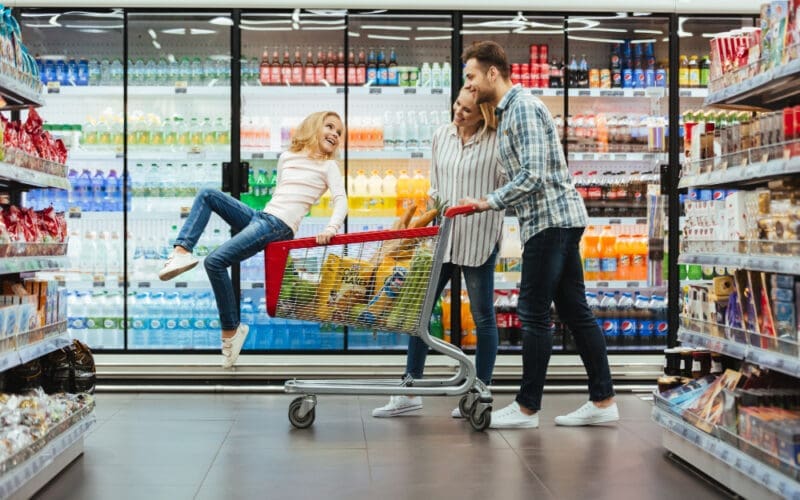 A cheerful young family with a child enjoying their shopping experience at Walmart