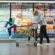 A cheerful young family with a child enjoying their shopping experience at Walmart