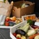 A family with groceries in an SUV heading home