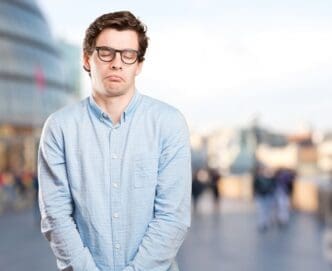 A relaxed young man expressing a sense of indifference and patience